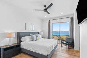 Bedroom featuring light wood-type flooring, access to exterior, ceiling fan, and recessed lighting