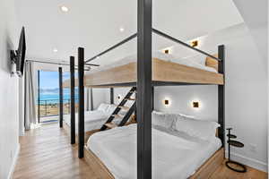 Bedroom with light wood-style flooring, recessed lighting, and access to exterior