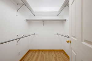 Walk in closet featuring light wood-type flooring