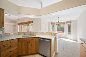Kitchen with light tile patterned floors, dishwasher, plenty of natural light, hanging light fixtures, and recessed lighting