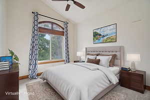 Bedroom with vaulted ceiling and a ceiling fan