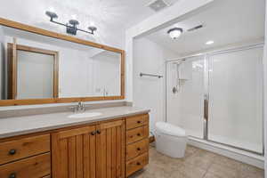 Bathroom featuring vanity, a shower stall, and recessed lighting