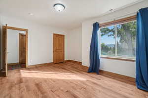Empty room featuring light wood-style flooring