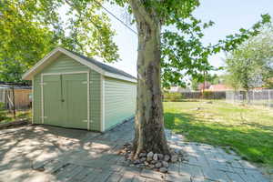 View of shed with a fenced backyard