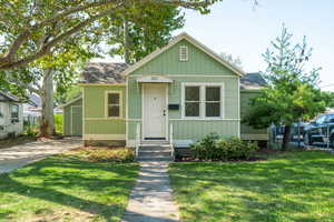 Bungalow featuring roof with shingles