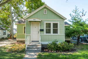 Bungalow-style house featuring roof with shingles