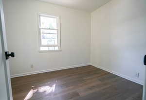 Spare room with dark wood-style flooring and a textured ceiling