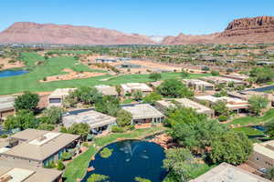 Aerial perspective of suburban area with a water and mountain view and a golf course