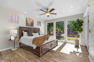 Bedroom featuring light wood finished floors, ceiling fan, and recessed lighting