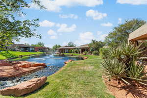 View of green lawn with a water view