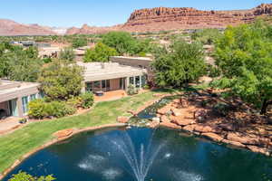 View of swimming pool featuring a patio, a lawn, a sunroom, and a water and mountain view