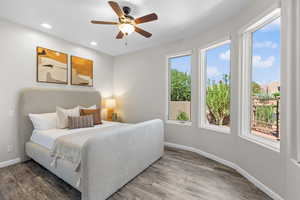 Bedroom featuring wood finished floors, a ceiling fan, and recessed lighting