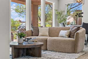 Living area with wood finished floors and a chandelier