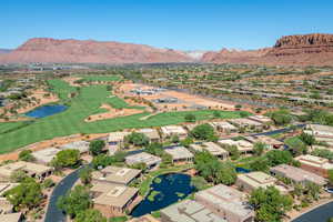 Aerial view of residential area featuring a water and mountain view and a golf course