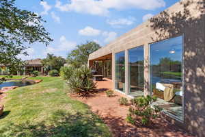View of grassy yard with a patio area and a ceiling fan