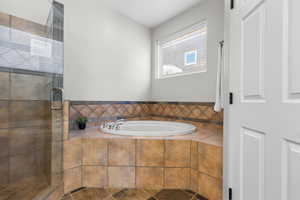Bathroom with a bath and a shower stall