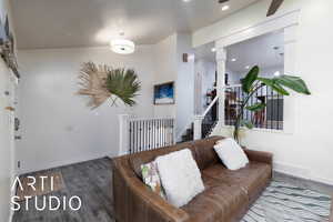 Living room with wood finished floors, recessed lighting, stairs, and ceiling fan