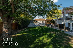 Fenced backyard featuring a pergola, a hot tub, and a patio