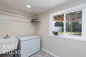 Laundry room with recessed lighting and tile patterned floors