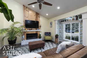 Living room with vaulted ceiling, wood finished floors, a premium fireplace, ceiling fan, and recessed lighting