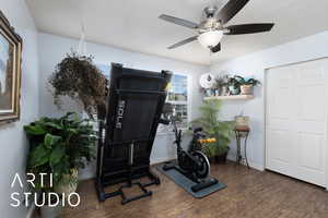 Workout area with wood finished floors and a ceiling fan