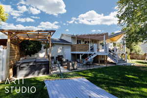 Back of property with a patio, stairway, a pergola, a hot tub, and a wooden deck