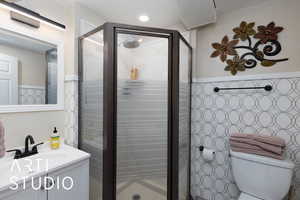 Full bathroom with a stall shower and vanity