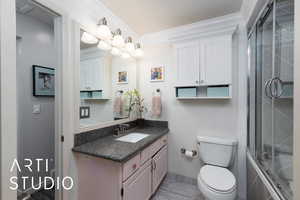 Full bathroom with crown molding, tiled shower / bath combo, and vanity