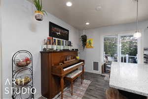 Dining area featuring dark wood-style flooring and recessed lighting