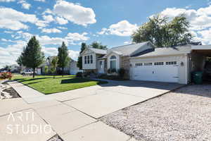 View of front facade with driveway, a front yard, a shingled roof, a garage, and a residential view