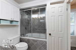Bathroom featuring tiled shower / bath and ornamental molding