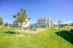 Community play area with a lawn and a mountain view