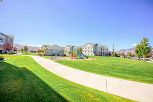 View of community featuring a yard, a mountain view, and a residential view