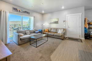 Living room with a mountain view, recessed lighting, and wood finished floors