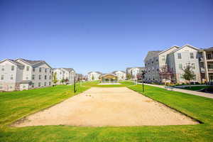 Surrounding community featuring volleyball court and a yard