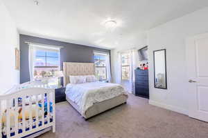 Bedroom featuring carpet flooring and baseboards