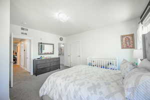 Bedroom featuring light colored carpet