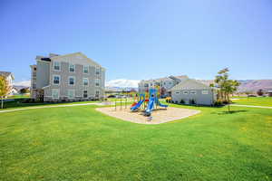 Community jungle gym with a yard and a mountain view