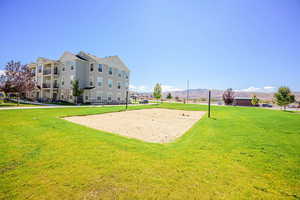 View of community with a yard, volleyball court, and a mountain view