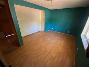 Unfurnished bedroom with wood finished floors and a textured ceiling
