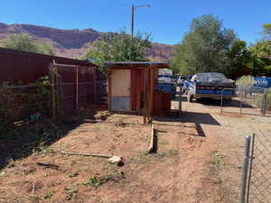 View of yard with exterior structure, an outbuilding, and a mountain view