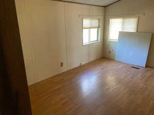 Spare room with wood finished floors and a textured ceiling