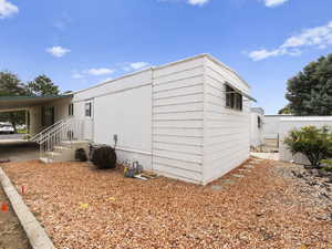 View of home's exterior featuring a carport and back door