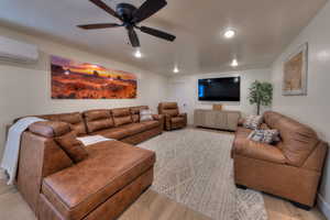 Downstairs living room with 75" TV. View of storage room door.