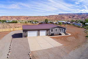 View of garage and driveway to downstairs entrance. Amazing view of red rocks.