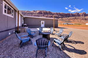 Back patio and firepit. View of separate basement entrance and parking (3 spaces)