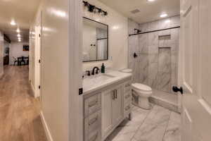 Downstairs bathroom #1. Has hallway access and another door with direct access to Primary Bedroom.
