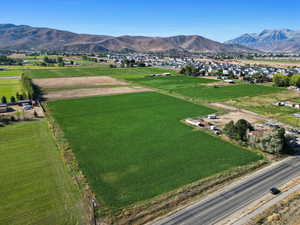 Overview of rural landscape with a mountain backdrop and extensive farmland
