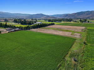Overview of rural landscape with a mountain backdrop and extensive farmland
