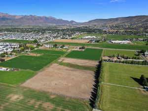 Aerial overview of property's location featuring a mountainous background and rural landscape
